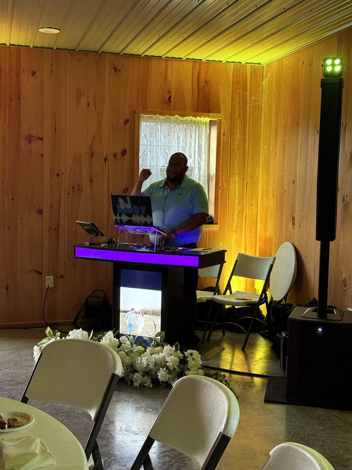 Travis at the booth with purple and yellow uplighting